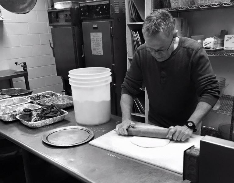 Man Rolling Out Dough